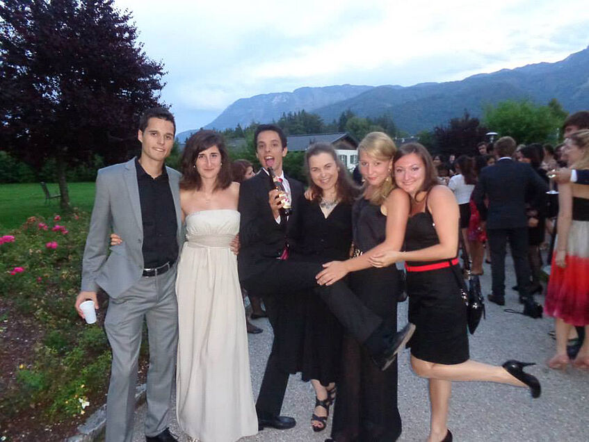 This picture was captured during the midsummer night's ball 2014.
</p>
<p>From left to right: Petar Brudar, Krystallenia Paniskaki, Nicolás Cabrera, Aleksandra Gjorgieska, Looes Herdersche, and Varvara Aleksić.
</p>
<p>I would also like to stress out the mountains that can be seen in the background. I have still the picture of them in front of my eyes, because I remember with how great desire I watched them during the German classes – dismal while I could not go outside. However, from this distance I see how important those German classes were. They actually were the best German classes I have ever participated in and they improved my German extremely. Those mountains thus, stand as a symbol of motivation in my mind. (© Peter Brudar)